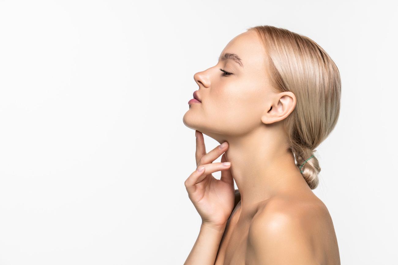 Beautiful young girl touching her face.